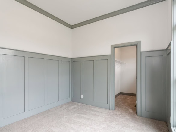 Interior room with light gray wainscoting and beige carpet at 3236 Catalpa Farms Dr.
