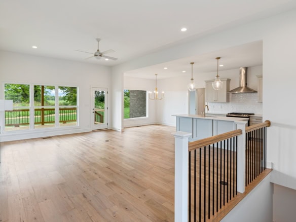 Spacious living area with large windows, hardwood floors, and contemporary lighting at 3236 Catalpa.