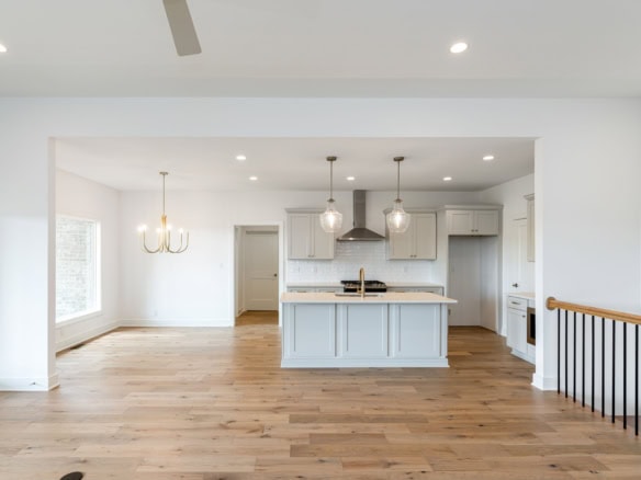 Bright, open-concept kitchen with white cabinets and island at 3236 Catalpa Farms Dr.