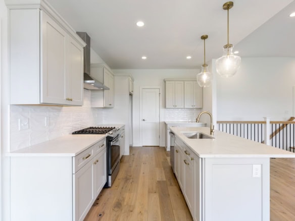 Modern kitchen with white cabinets and island at 3236 Catalpa Farms Dr.