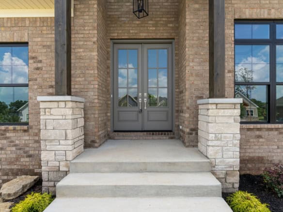 Entrance door with brick facade and stone accents.