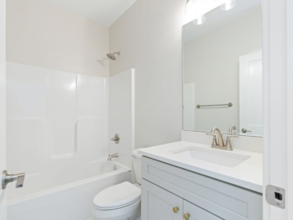 Bathroom with white bathtub, toilet, and vanity in a new home at 3236 Catalpa Farms Dr.