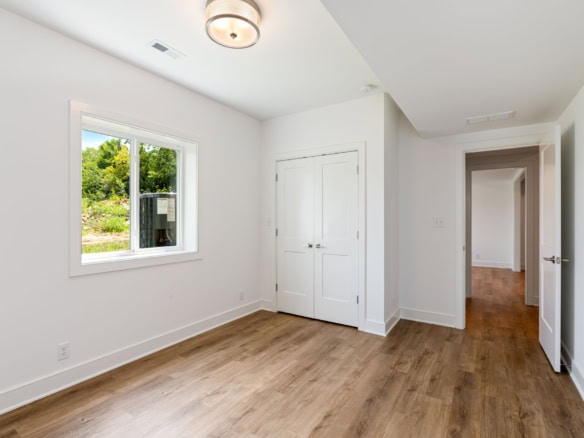 Bright, airy room with large window and white walls at 3236 Catalpa Farms Dr.