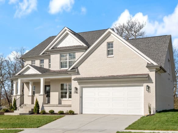 Beautiful new construction home with a spacious front porch and attached garage.