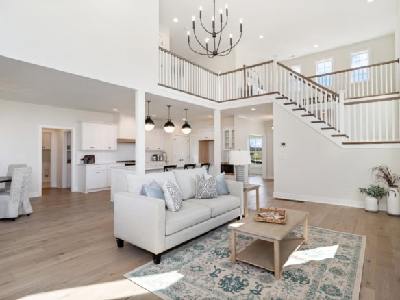 Spacious living area with high ceilings, large windows, and contemporary decor.