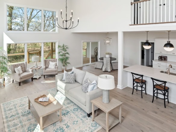 Spacious living area with large windows, bright decor, and contemporary furniture at 3320 Catalpa Fa.