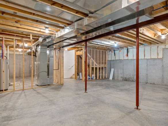 New home construction site with framing and electrical rough-ins in progress.