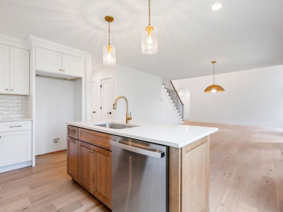 Bright, spacious kitchen with white cabinets and a central island.