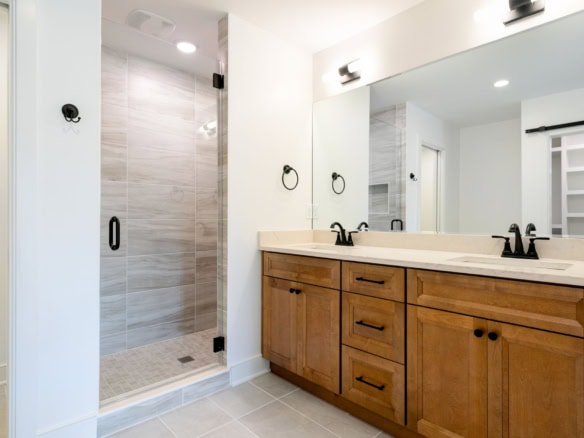 Beautiful bathroom featuring a wooden vanity and spacious walk-in shower.