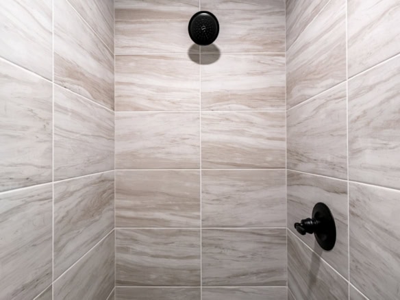 Modern tiled shower with black fixtures at 3322 Catalpa Farms Dr.