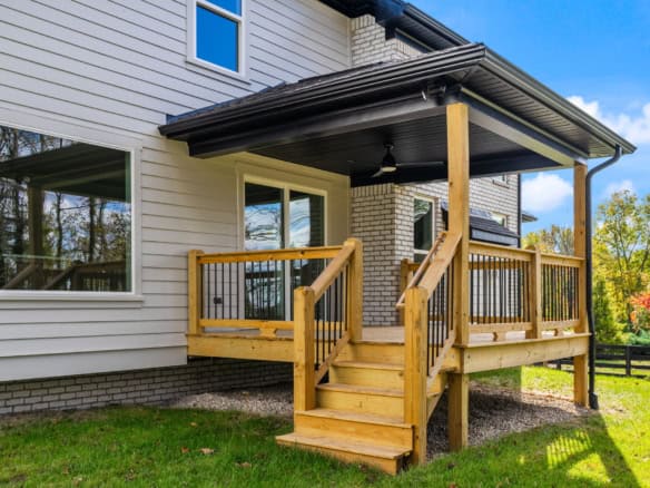 Custom wooden deck with railing and stairs at 3322 Catalpa Farms Dr.