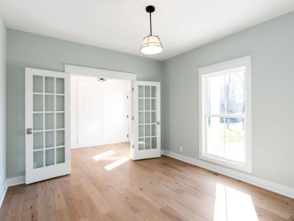 Bright, airy living room with large windows and French doors.