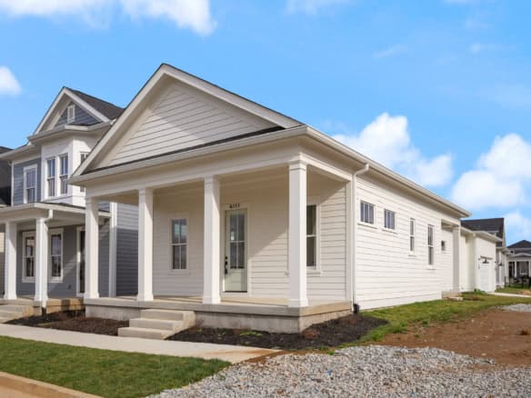 White house with front porch and columns at 6111 Passionflower Dr.