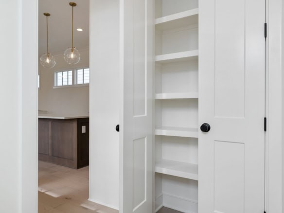 Custom built-in white storage closet in a modern home interior.