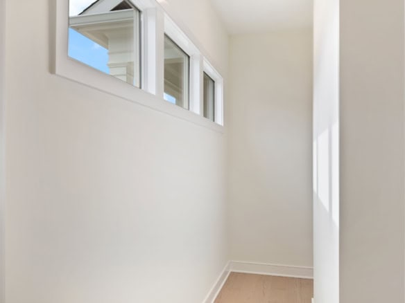 Bright interior corner with large windows and white walls at 6111 Passionflower Dr.