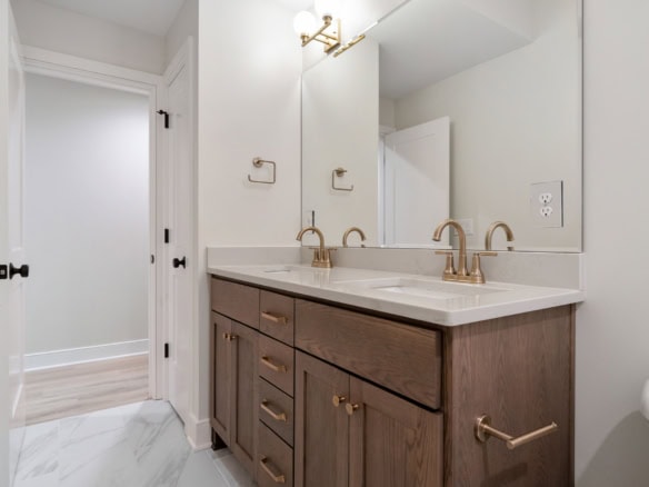Modern bathroom vanity with dual sinks and elegant fixtures.