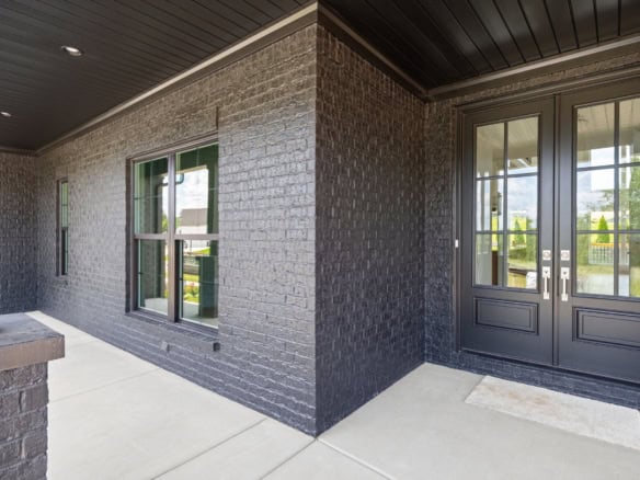 Beautiful brick home facade with black-framed windows and doors at 6207 Brentwood Dr.
