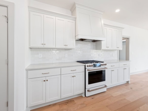 Kitchen renovation with white cabinets and modern appliances.