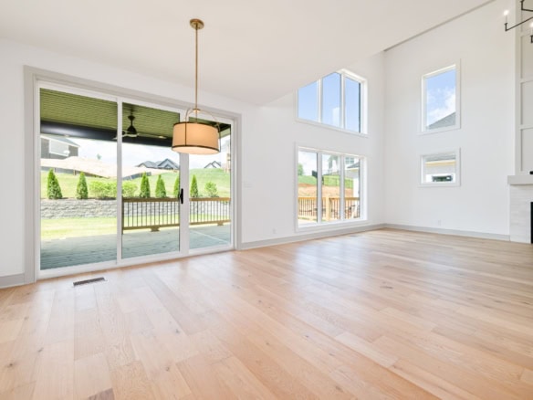 Spacious interior featuring expansive windows and light wood flooring, perfect for a contemporary ho.