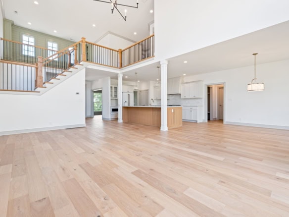 Spacious open-concept living area with hardwood floors and high ceilings at 6207 Brentwood Dr.