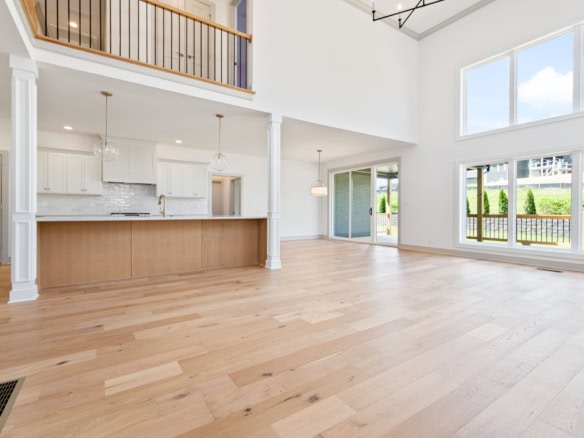 Spacious interior featuring tall windows, high ceilings, and a bright, airy atmosphere in a newly bu.
