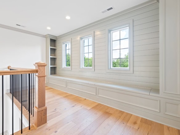Bright interior featuring spacious windows and elegant wall details.