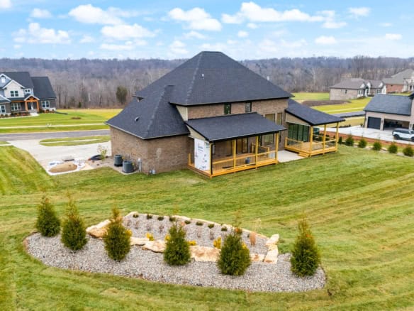 A modern house with a landscaped yard, porch, and surrounding neighborhood.
