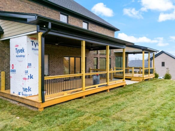 Covered wooden porch with railing at 6307 Brentwood Dr.