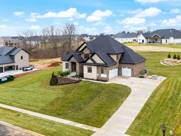 Beautiful new construction home with landscaped yard and driveway.