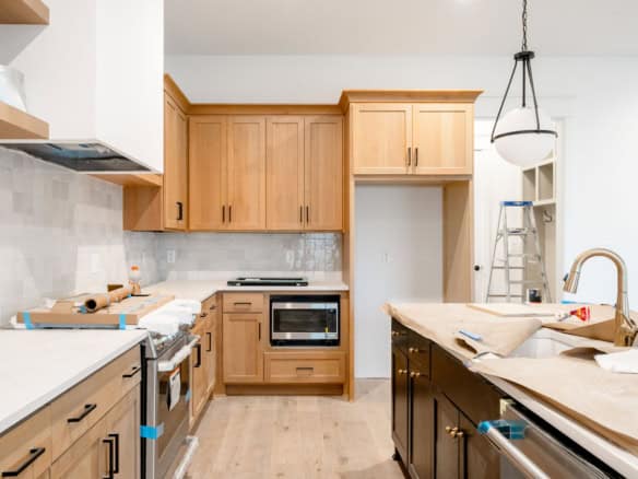 New kitchen with wooden cabinets, island, and modern appliances.