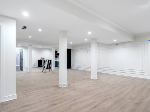 Bright, spacious interior with white walls and wood flooring.