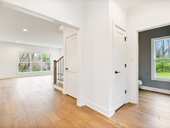 Bright, spacious living area with large windows and hardwood floors.