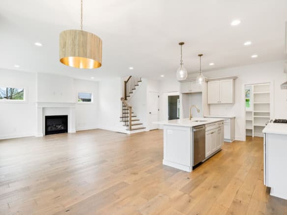 Spacious kitchen and living area with hardwood floors and natural light.