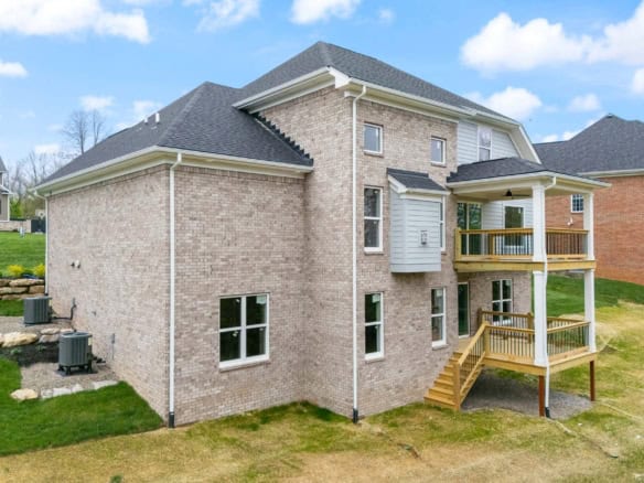Modern brick house with multiple decks and large windows at 6505 Hypoint Ridge Rd.