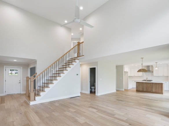 Bright, spacious open-concept living area with high ceilings and hardwood floors.