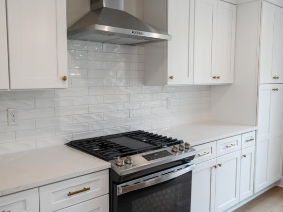 Bright kitchen interior with white cabinets and modern appliances.