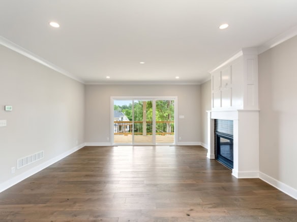 Bright living room with large sliding doors and fireplace.