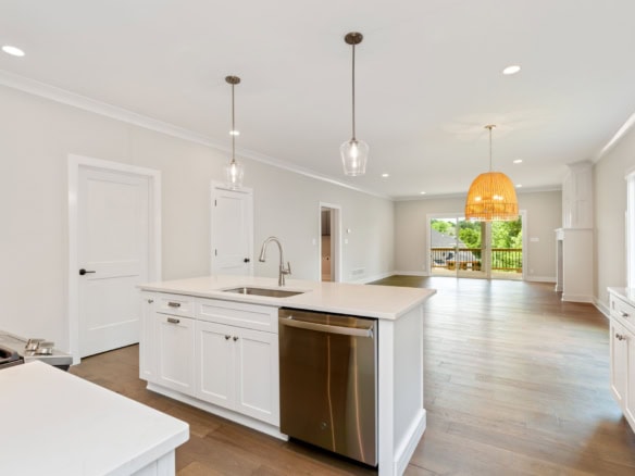Bright, spacious kitchen with white cabinets and hardwood floors.