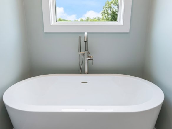 Elegant freestanding bathtub in a bright, contemporary bathroom.