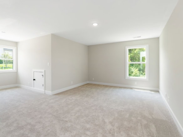 Bright, spacious interior with large windows and neutral decor.