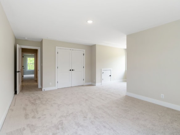 Bright, spacious interior with neutral walls and plush carpet.