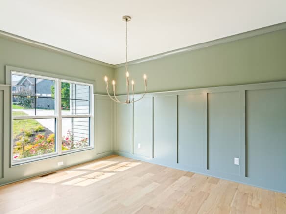 Bright, spacious living room with large window and modern decor.
