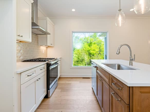 Kitchen with white cabinetry, stainless steel appliances, and a central island.