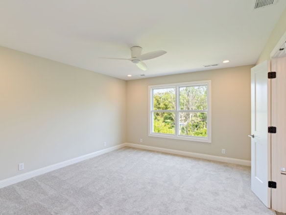Interior view of a bright, spacious room with large windows and neutral decor.