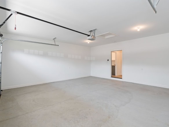 Garage interior with white walls and concrete floor at 6712 Hypoint Ridge Rd.
