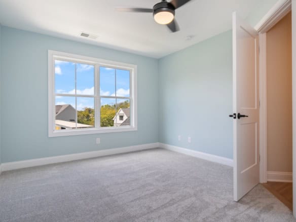 Bright bedroom with a large window and fresh paint, part of 6713 Hypoint Ridge Rd.
