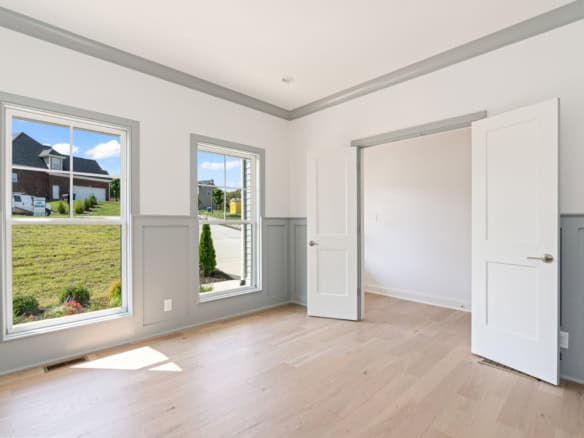 Bright, spacious interior room with large windows and white walls.