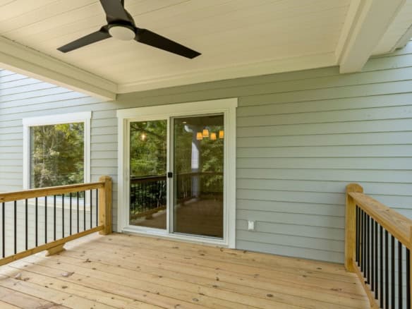 Screened porch with ceiling fan and wooden deck at 6714 Hypoint Ridge Rd.