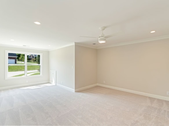 Bright, spacious living room with large window and neutral decor.