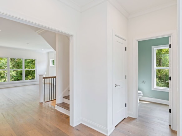 Interior view of a new construction home showcasing bright, open living space and bathroom.
